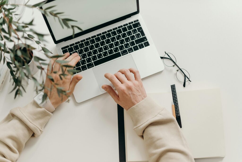 Image of hands typing on laptop.